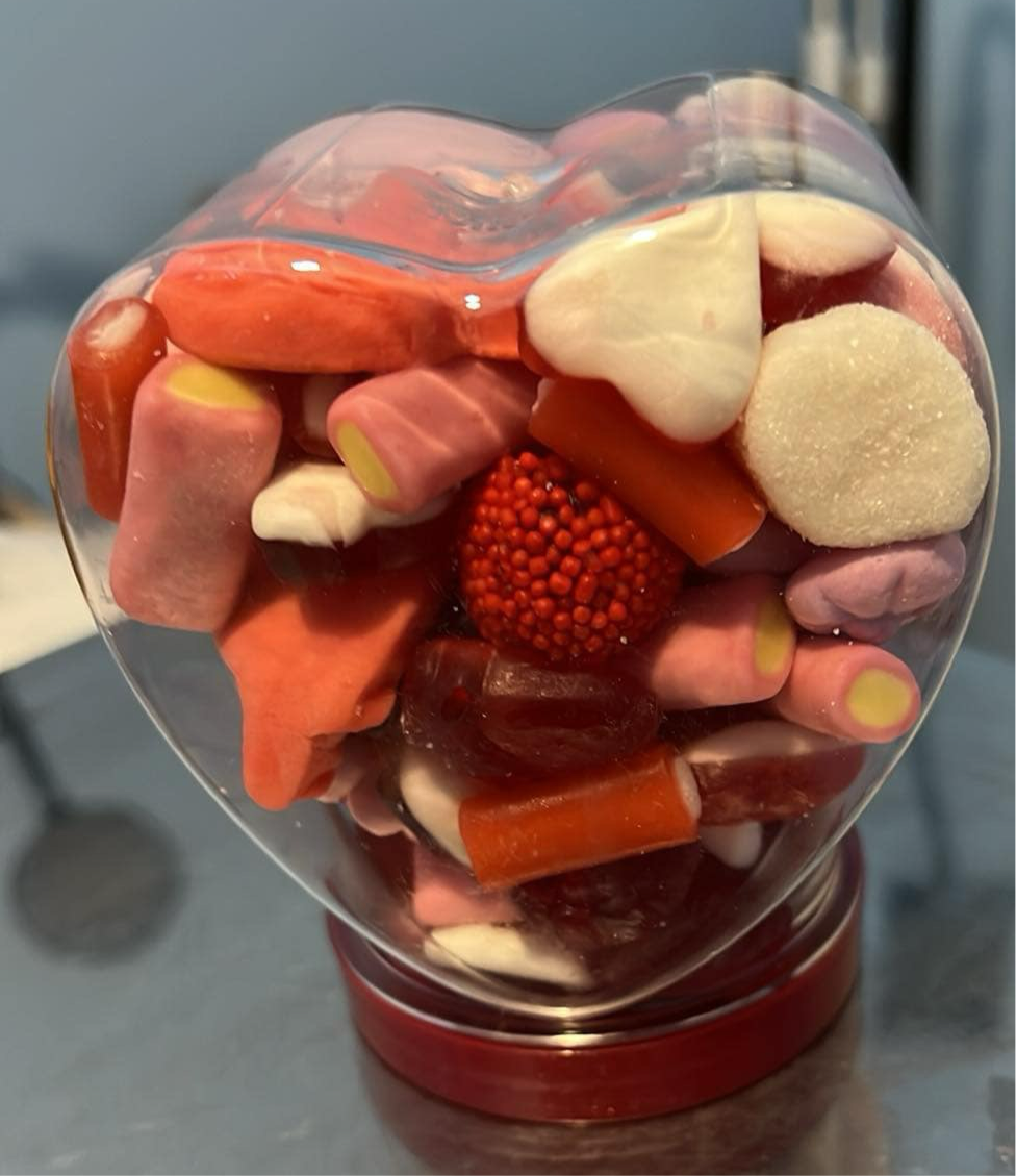 Heart jar filled with sweets.