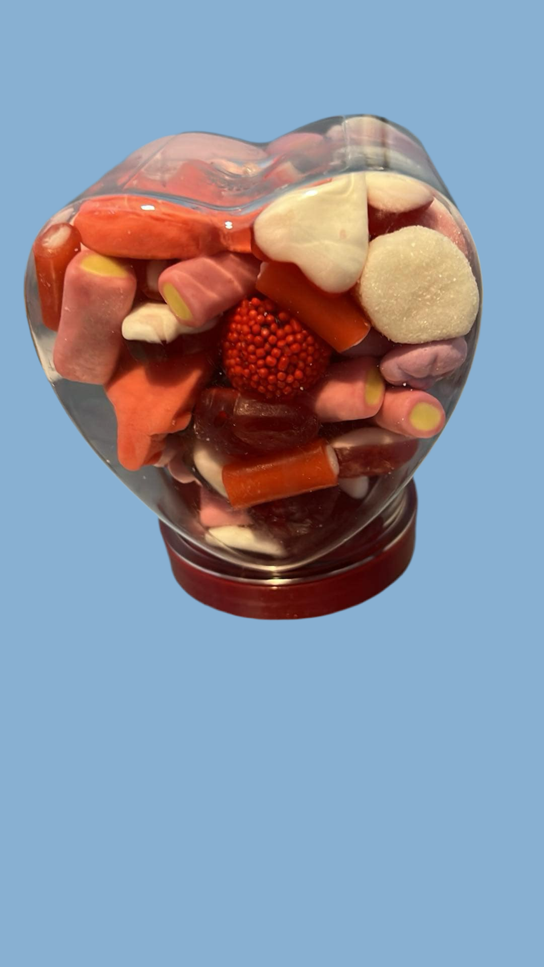 Heart jar filled with sweets.