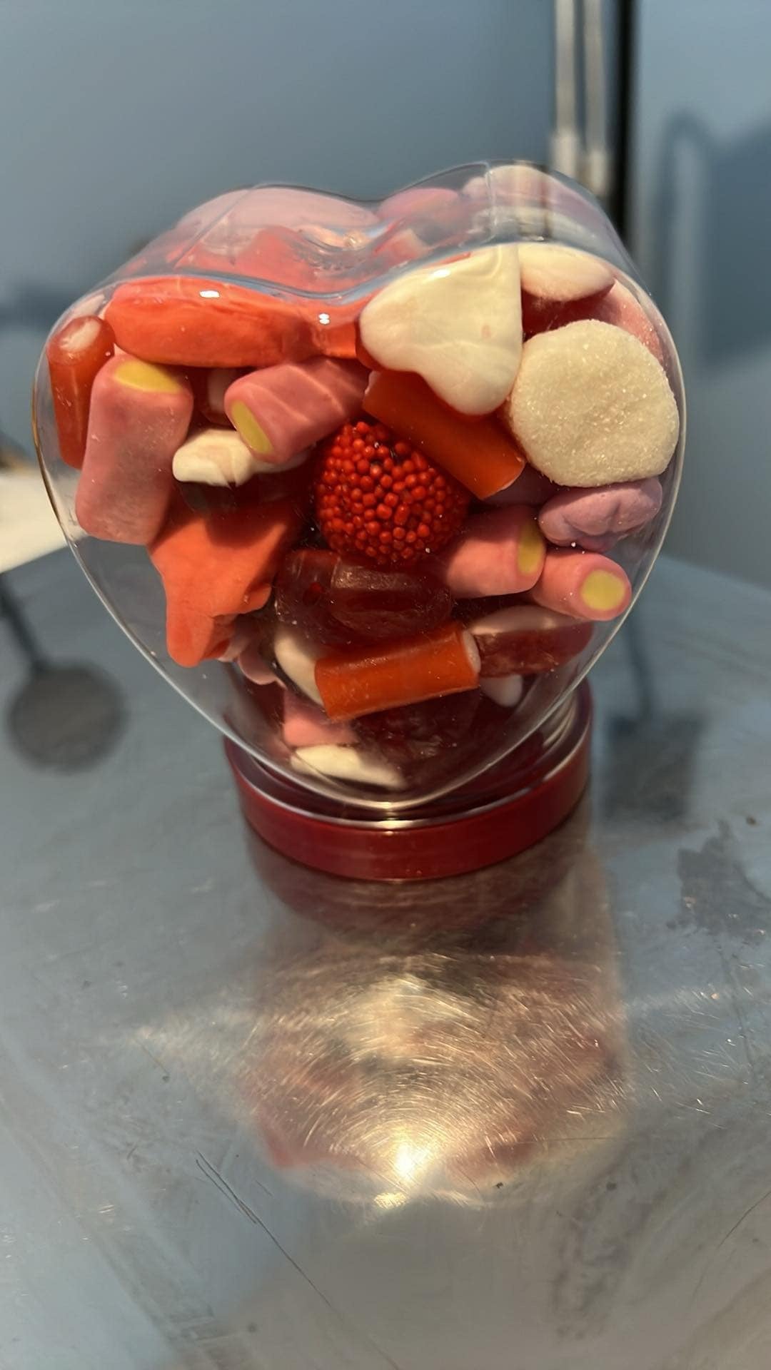 Heart jar filled with sweets.